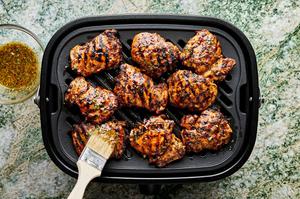 chicken being grilled and brushed with honey mustard marinade