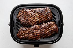 skirt steak marinated in soy sauce, garlic, salt, pepper and red pepper flakes being grilled