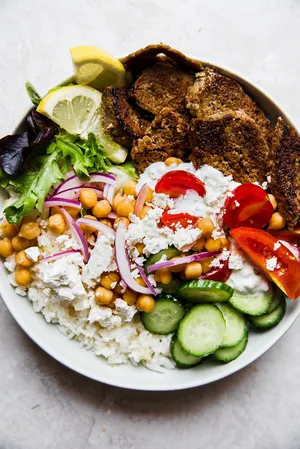 gyro bowl with cucumbers, lemon rice, feta, red onion, tomatoes, lettuce and gyro meat