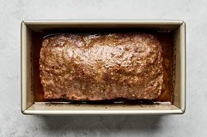 homemade gyro meat hot out of the oven in a loaf pan made with beef, lamb, onion and spices