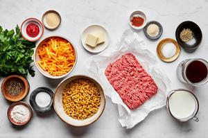 ground beef, butter, pasta, shredded cheese, beef stock, milk and spices in prep bowls