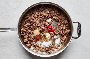 ground beef, tomato paste, garlic powder, onion powder, Italian seasoning, chili powder, sugar, salt, and pepper in a skillet