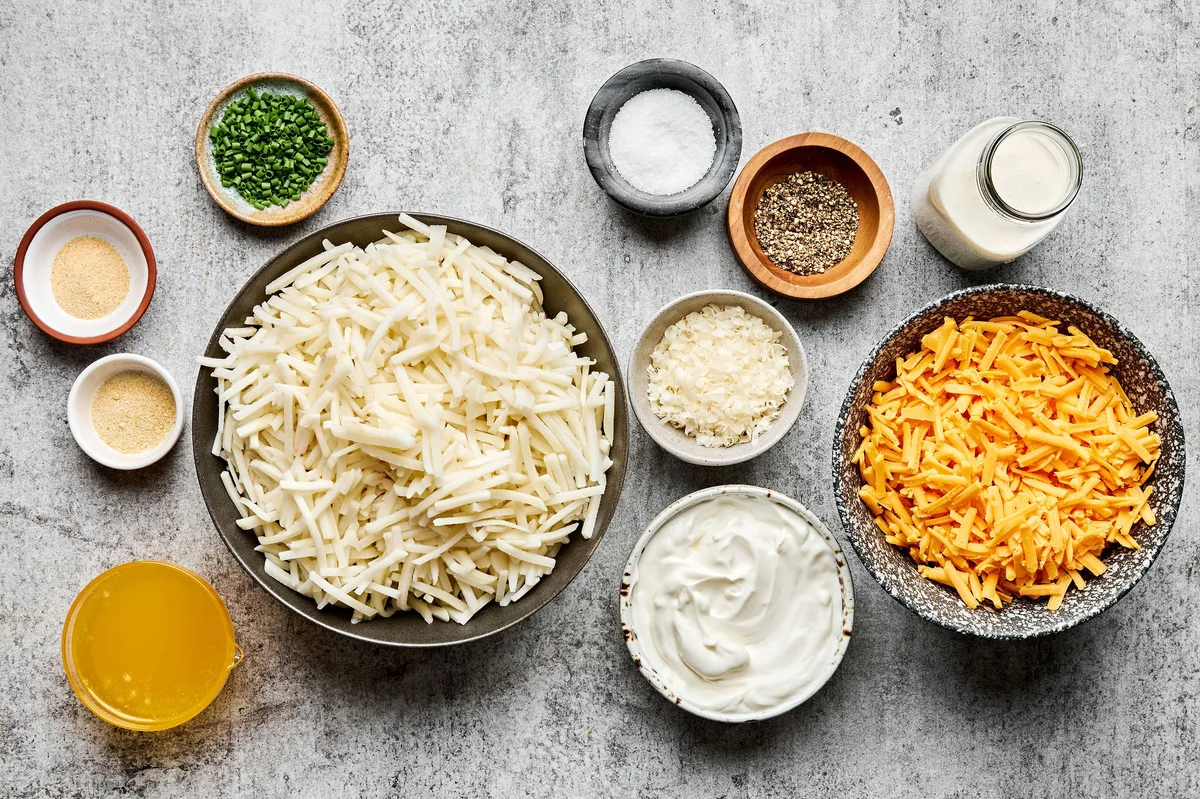 shredded potatoes, cheese, sour cream, heavy cream, butter, garlic powder, onion powder, salt, and pepper in prep bowls