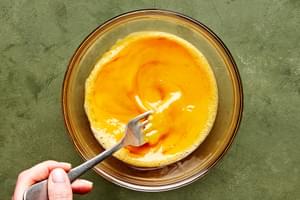 eggs being whisked with sesame oil and coconut aminos in a bowl