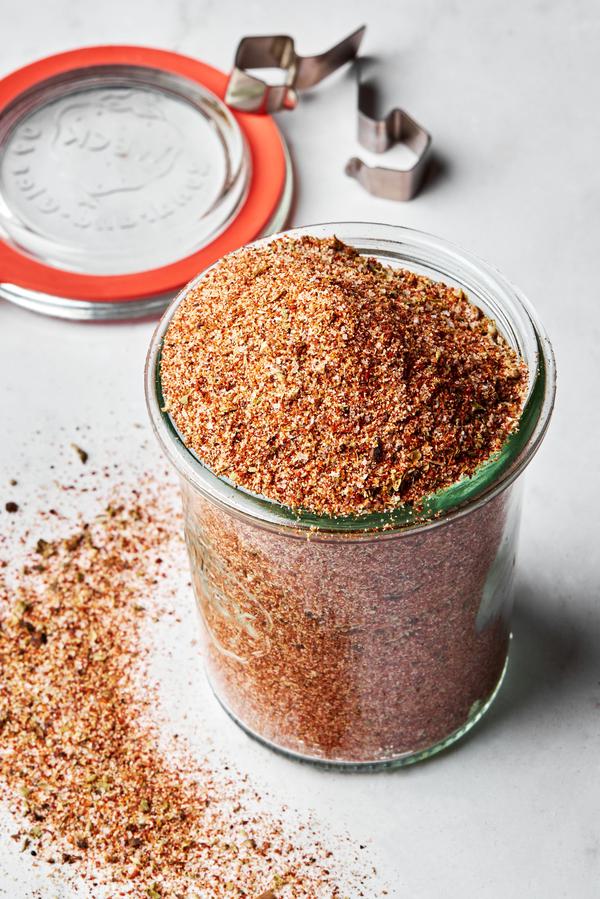 a jar of homemade taco seasoning made with chili powder, paprika, cumin, onion powder, garlic powder, oregano, salt & pepper