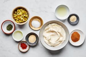 mayonnaise, chopped dill pickles, pickle juice, lemon juice, Old Bay seasoning, garlic & onion powder, sugar, dill, cayenne.