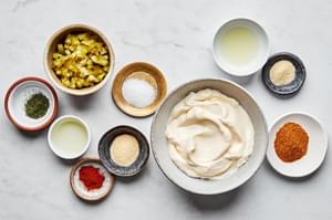mayonnaise, chopped dill pickles, pickle juice, lemon juice, Old Bay seasoning, garlic & onion powder, sugar, dill, cayenne.