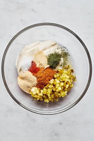mayonnaise, pickles, pickle juice, lemon juice, Old Bay, garlic & onion powder, sugar, dill, cayenne in a bowl