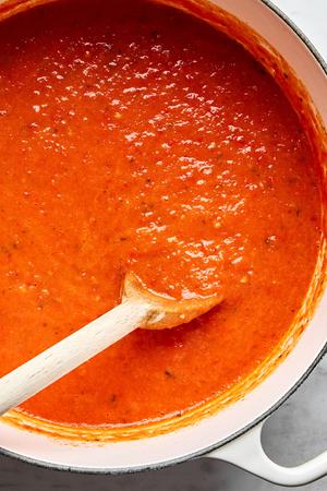 homemade tomato sauce in a pot made with tomatoes, olive oil, salt, garlic and fresh basil