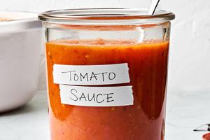 a jar of homemade tomato sauce made with tomatoes, olive oil, salt, garlic and fresh basil