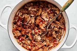 homemade honey chipotle pulled pork being stirred in a pot