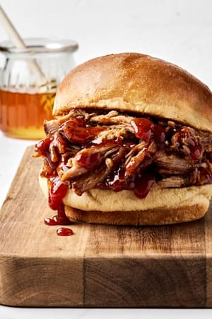 homemade honey chipotle pulled pork being served on a hamburger bun