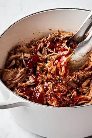 homemade honey chipotle pulled pork being stirred in a pot