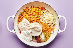 Mexicorn, cream cheese, sour cream, mayo, jalapeño, red onion, cheese & spices  being combined in a skillet