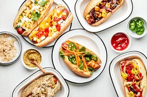 different style hot dogs one plates like hawaiian, italian-american , mexican, banh mi, chicago and the deli dog