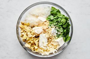 cream cheese, mayonnaise, parmesan, garlic, basil, garlic powder, salt, artichoke hearts, spinach & mozzarella in a bowl