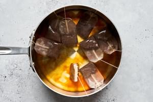 black tea bags steeping in boiling water