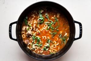 tomato pasta pork meatball soup with basil in a soup pot
