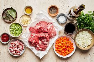 roast, spices, pancetta, onion, carrot, red wine, tomato paste and fresh parsley in prep bowls