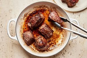 roast seasoned with salt and pepper being browned in olive oil in a pot