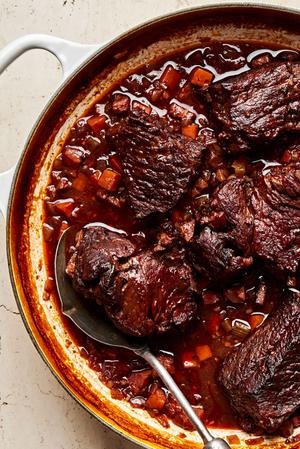 Italian pot roast made with spices, onion, carrot, celery and red wine in a pot