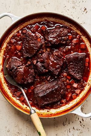 Italian pot roast made with spices, onion, carrot, celery and red wine in a pot
