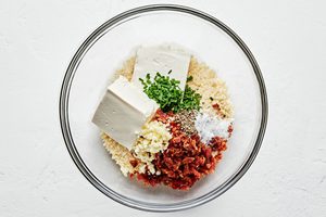 jalapeno popper filling being made in a bowl with parmesan, cream cheese, bacon, chives, butter, panko & spices