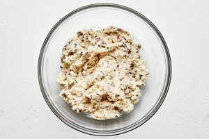 jalapeno popper filling being made in a bowl with parmesan, cream cheese, bacon, chives, butter, panko & spices
