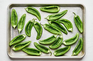 jalapeños sliced in half and deseeded, prepped to be filled to make jalapeno poppers, a great party appetizer