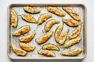 homemade jalapeño poppers on a baking sheet fresh out of the oven filled