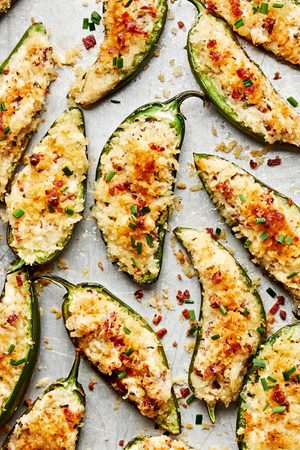 Homemade jalapeño poppers on a baking sheet fesh out of the oven. The perfect party or game day appetizer!
