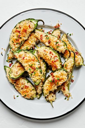 A plate of homemade jalapeno poppers with creamy filling & a crispy golden breading. The perfect party or game day appetizer!