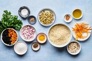 basmati rice, pistachios, almonds, shallot, turmeric, cumin, cinnamon, all spice, salt, orange zest and dried fruit in bowls