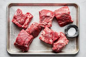 chuck roast cut in to 2 inch pieces salted on a baking sheet