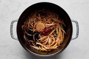onions, garlic, ginger, beef stock, gochujang paste, brown sugar and soy sauce cooking in a pot