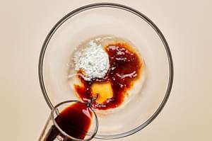 soy sauce, vinegar, brown sugar, and cornstarch being mixed in a bowl