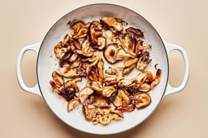 mushrooms tossed with soy sauce, vinegar, brown sugar, and cornstarch cooking in a skillet