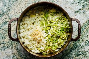 raw leeks, onions and garlic in a large dutch oven.