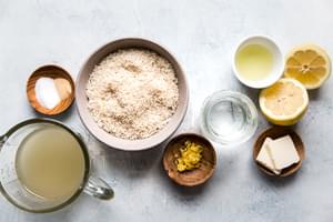 ingredients for lemon rice, lemon zest, lemon juice, butter, chicken stock, salt and garlic powder on the counter
