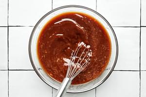 lemon zest, lemon juice, brown sugar, soy sauce, honey, ginger powder, garlic powder whisked in a bowl with cornstarch slurry