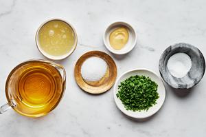 lemon juice, dijon mustard, sugar, salt, olive oil and chives in prep bowls to make homemade lemon vinaigrette