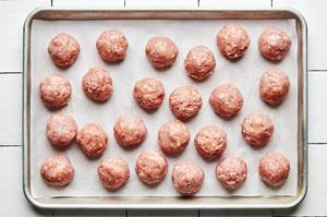 lemongrass meatballs on a baking sheet made with ground chicken, lemongrass, brown sugar, salt, garlic and ginger
