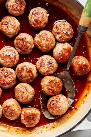 lemongrass chicken meatballs in a skillet in a sweet brown sugar sauce