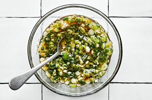 green onion oil in a bowl made with green onions, vegetable oil, soy sauce, vinegar, fish sauce, garlic, and ginger