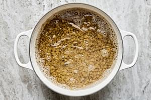 lentils cooking in a pot of boiling water