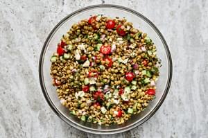 lentil salad made with cucumber, tomato, red onion, garlic, parsley, lemon juice, feta, olive oil, vinegar & spices