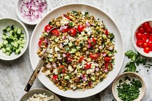 lentil salad made with cucumber, tomato, red onion, garlic, parsley, lemon juice, feta, olive oil, vinegar & spices