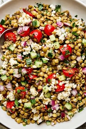 lentil salad made with cucumber, tomato, red onion, garlic, parsley, lemon juice, feta, olive oil, vinegar & spices