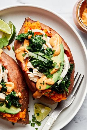 baked sweet potatoes loaded with sautéed kale and onions, chicken, avocado, chipotle cashew cream sauce & cilantro