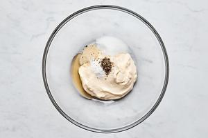 mayo, honey, sugar, onion powder, pepper and salt being whisked together in a bowl